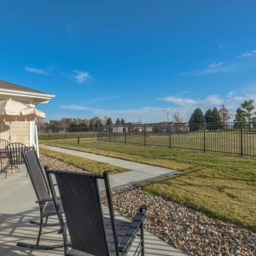 Outdoor seating area with views of the fenced yard