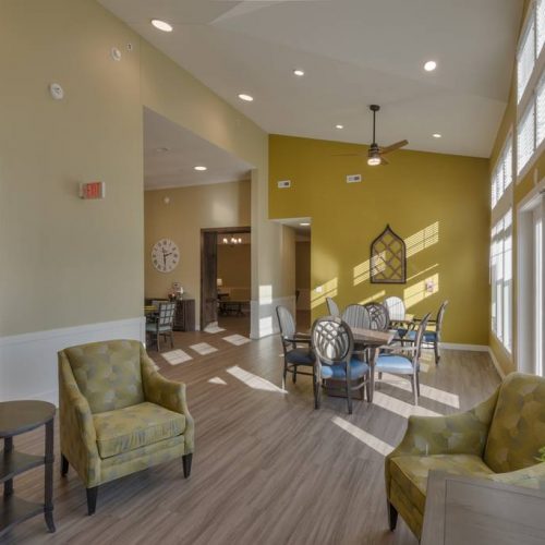 Bright common area with seating and dining tables