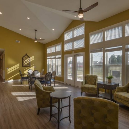 Bright common area with seating and large windows