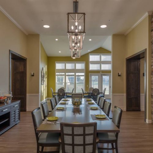 Bright dining room with a long table and chairs