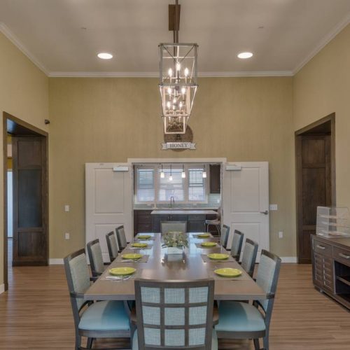 Bright dining room with a long table and decorative lights