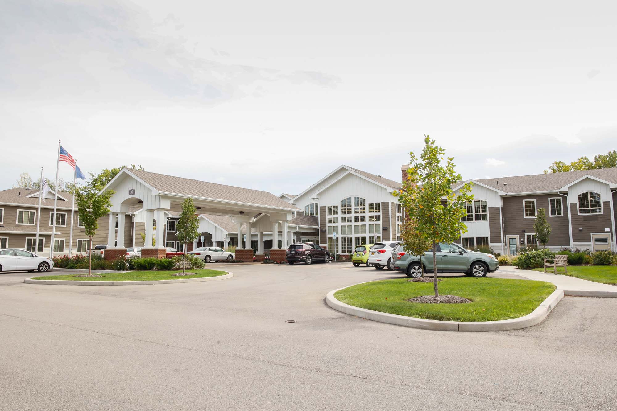 Exterior view of the senior living facility with entrance and landscaping