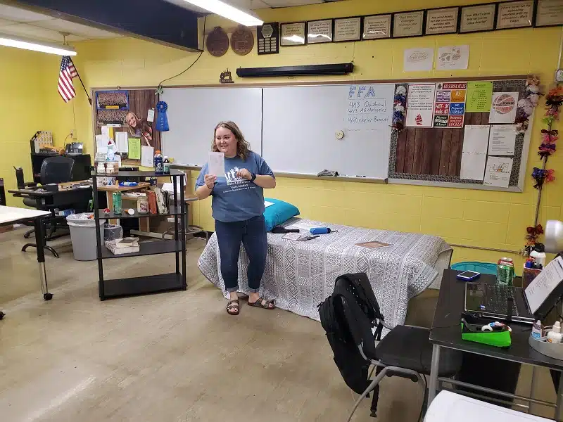 Staff member in a classroom with colorful walls