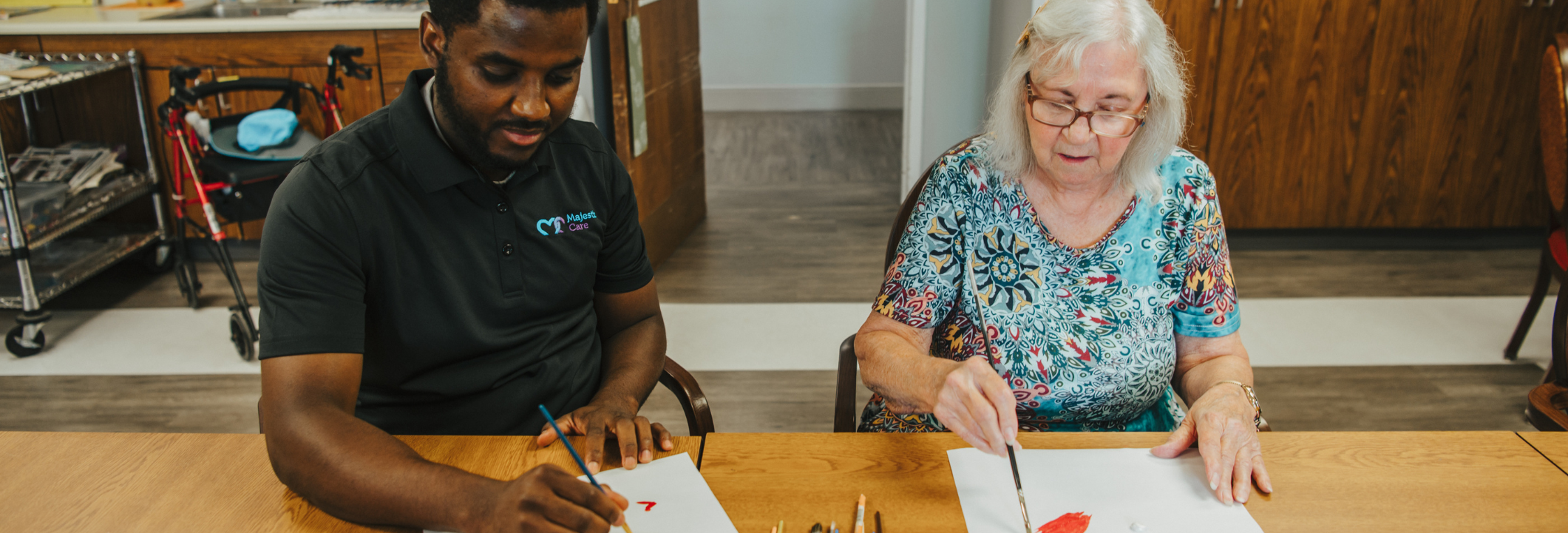 Resident and staff engaged in an art activity