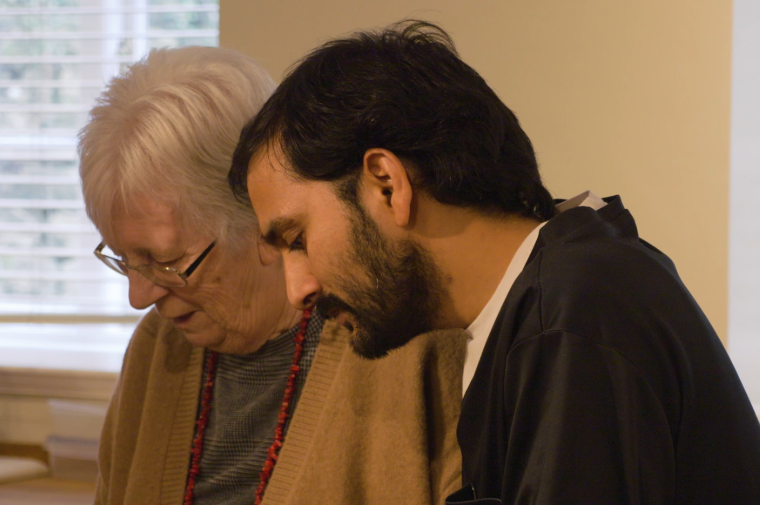 A caregiver and resident engaged together.