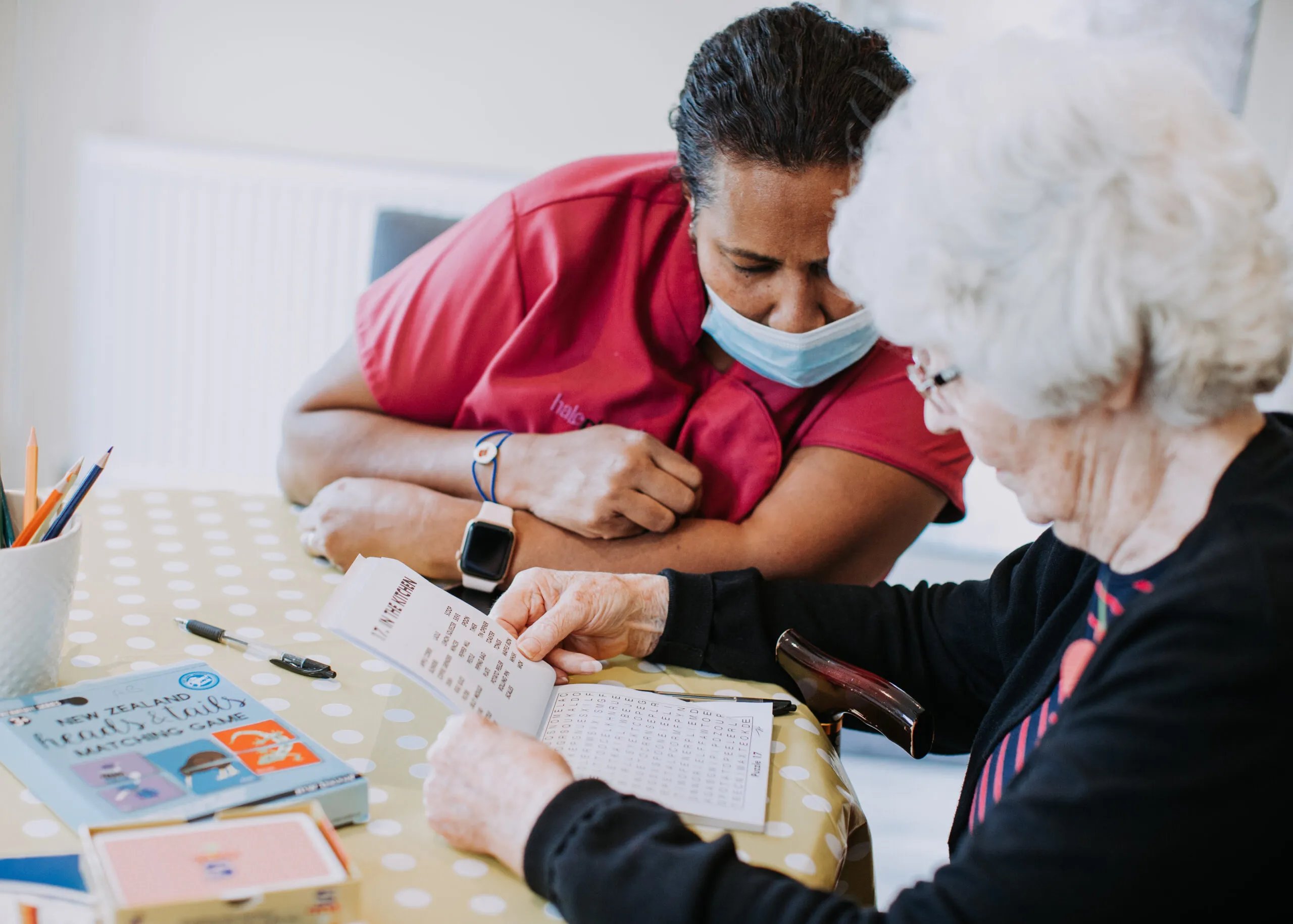 Staff member assisting a resident with an activity.