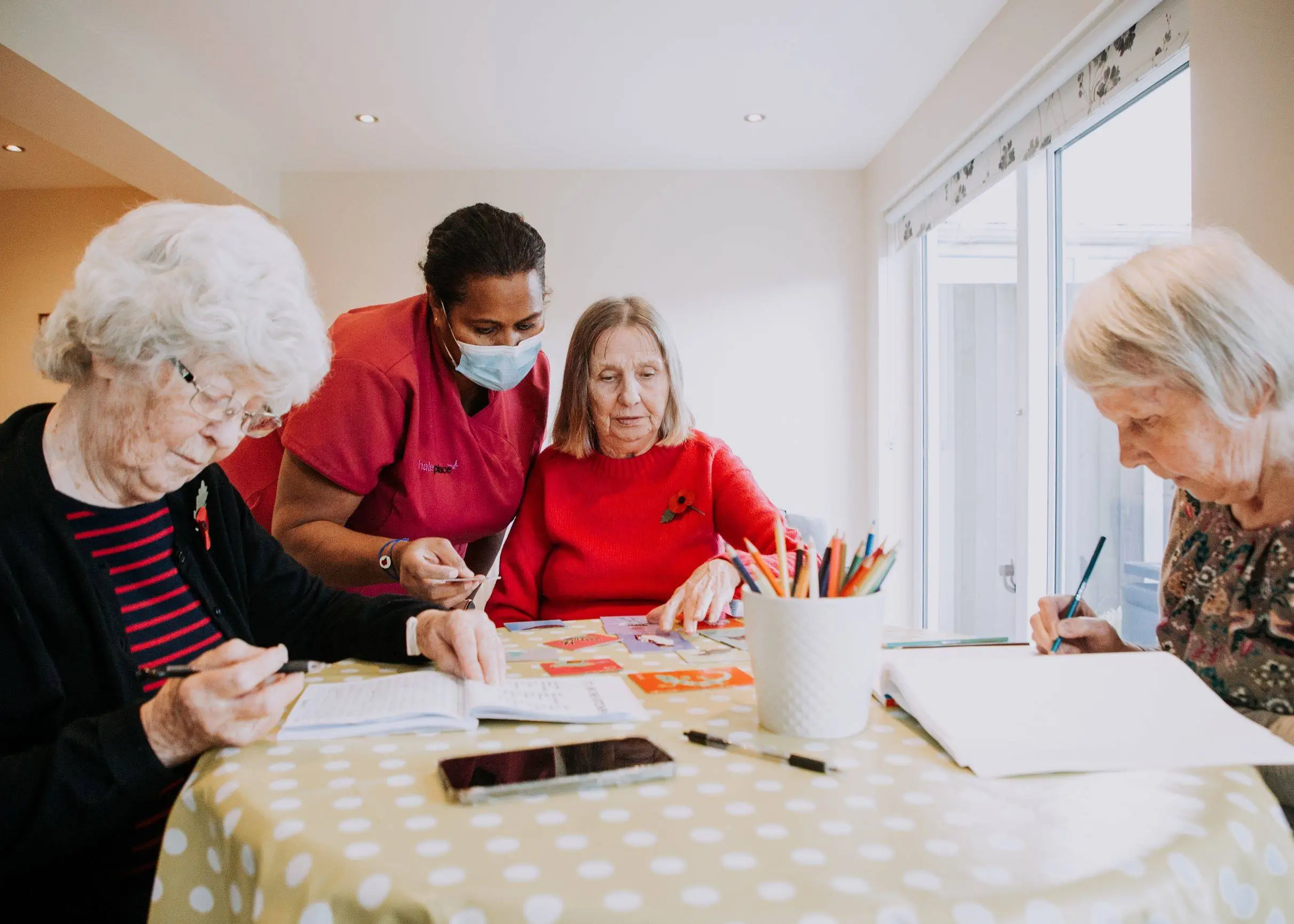 Residents and staff engaged in a creative activity together.