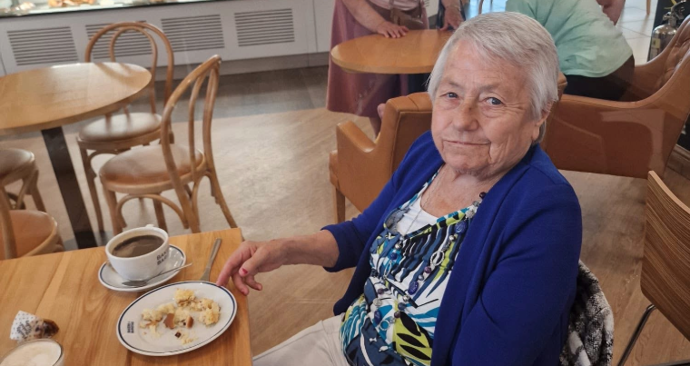 Resident enjoying a meal in the dining area.