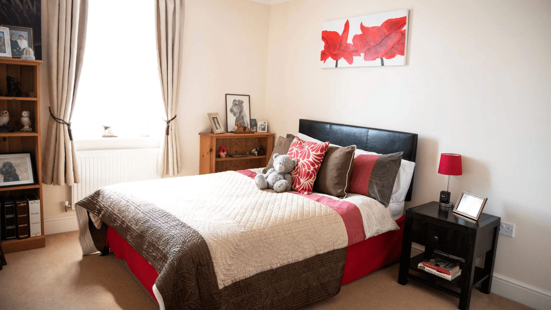 Cozy bedroom with a decorated bed and personal items.
