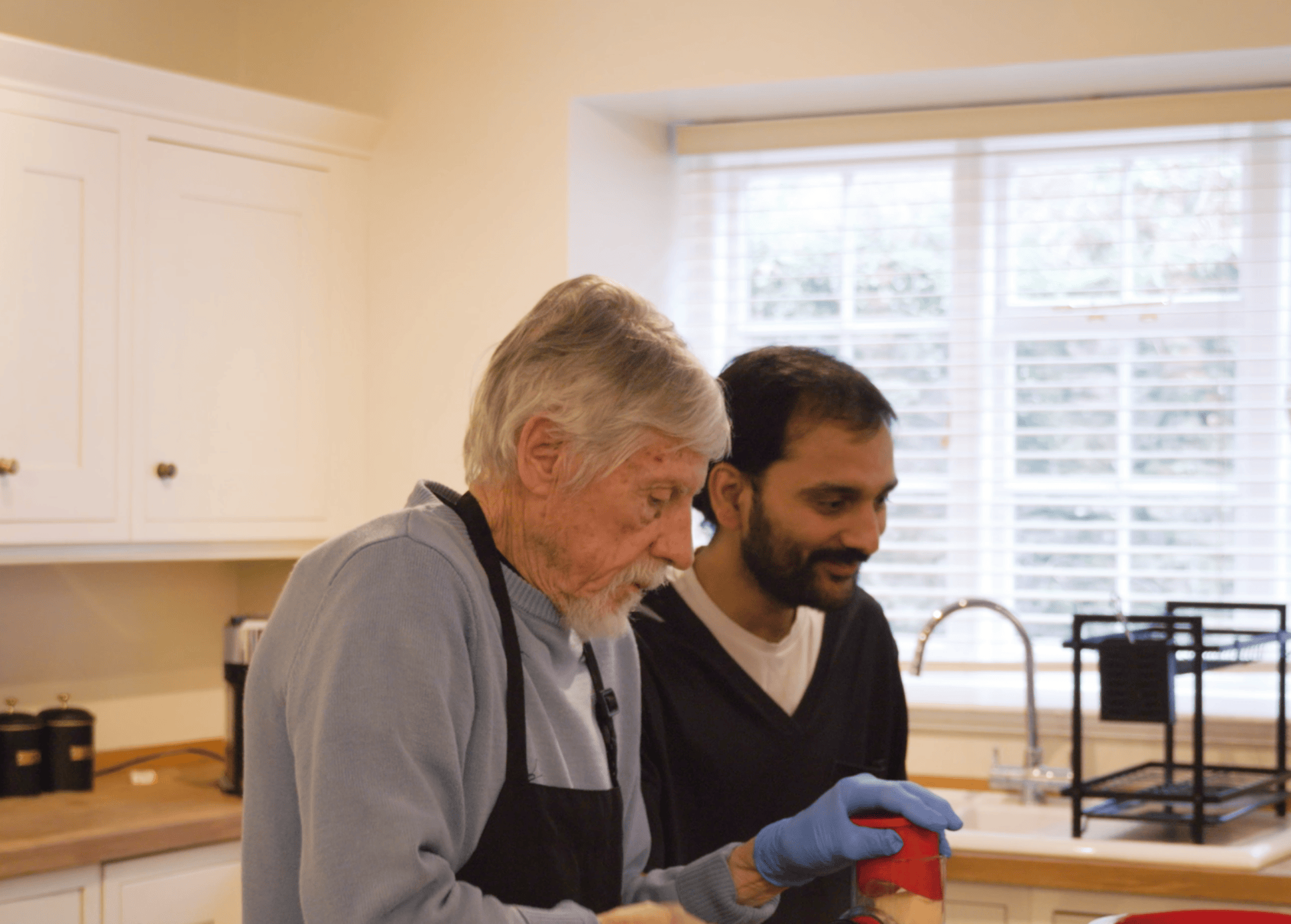 Two men cooking together in a kitchen