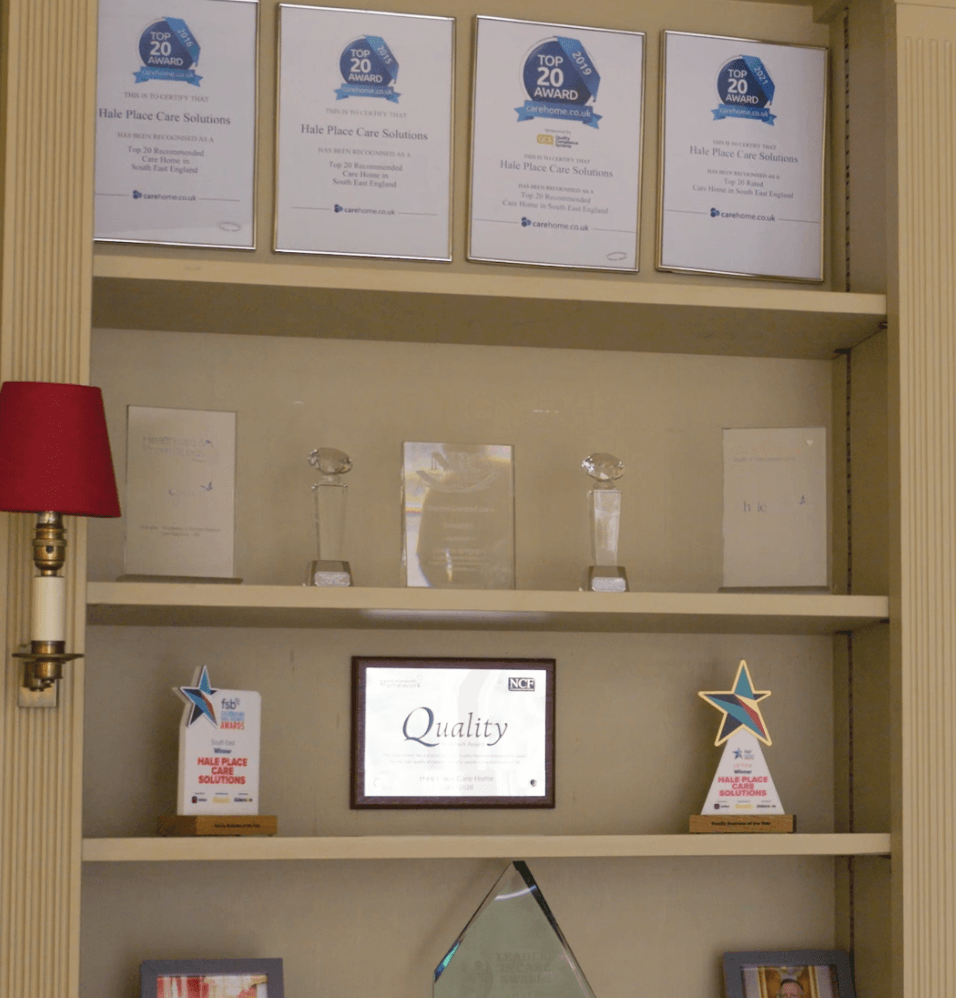 Awards and recognitions displayed on a shelf.