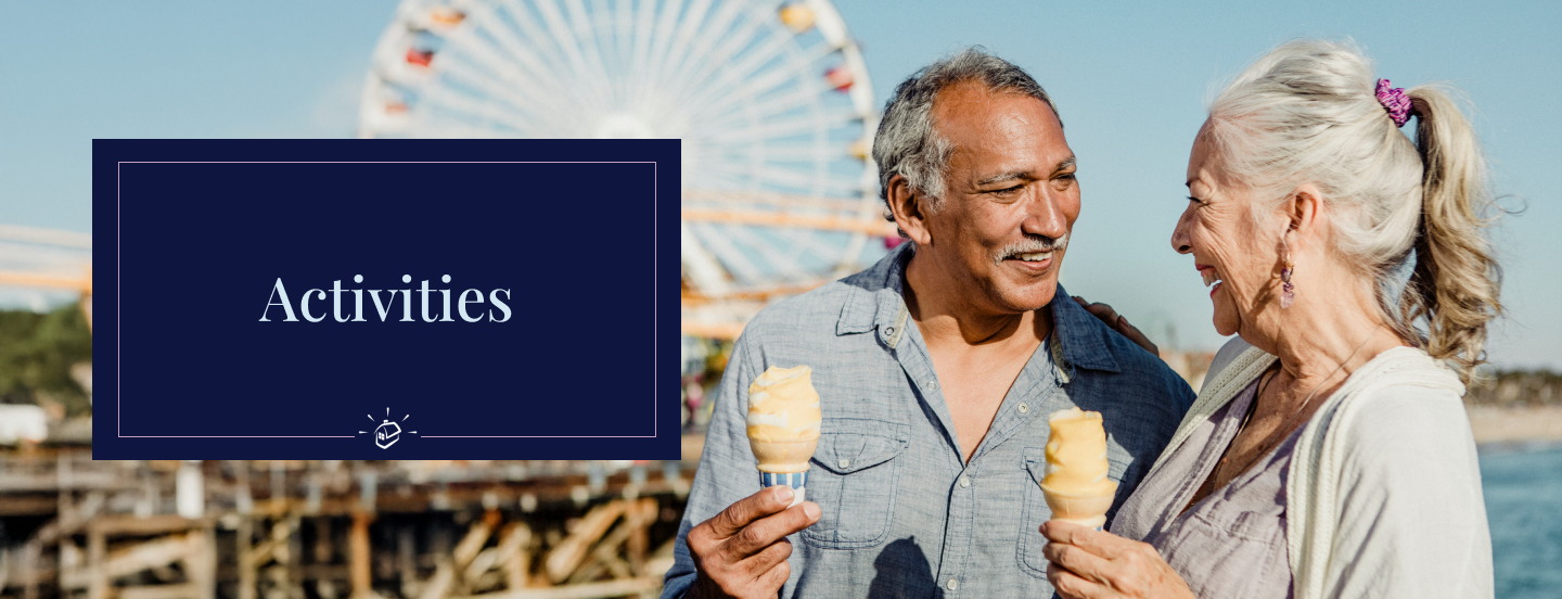 Two seniors enjoying ice cream at an outdoor event.