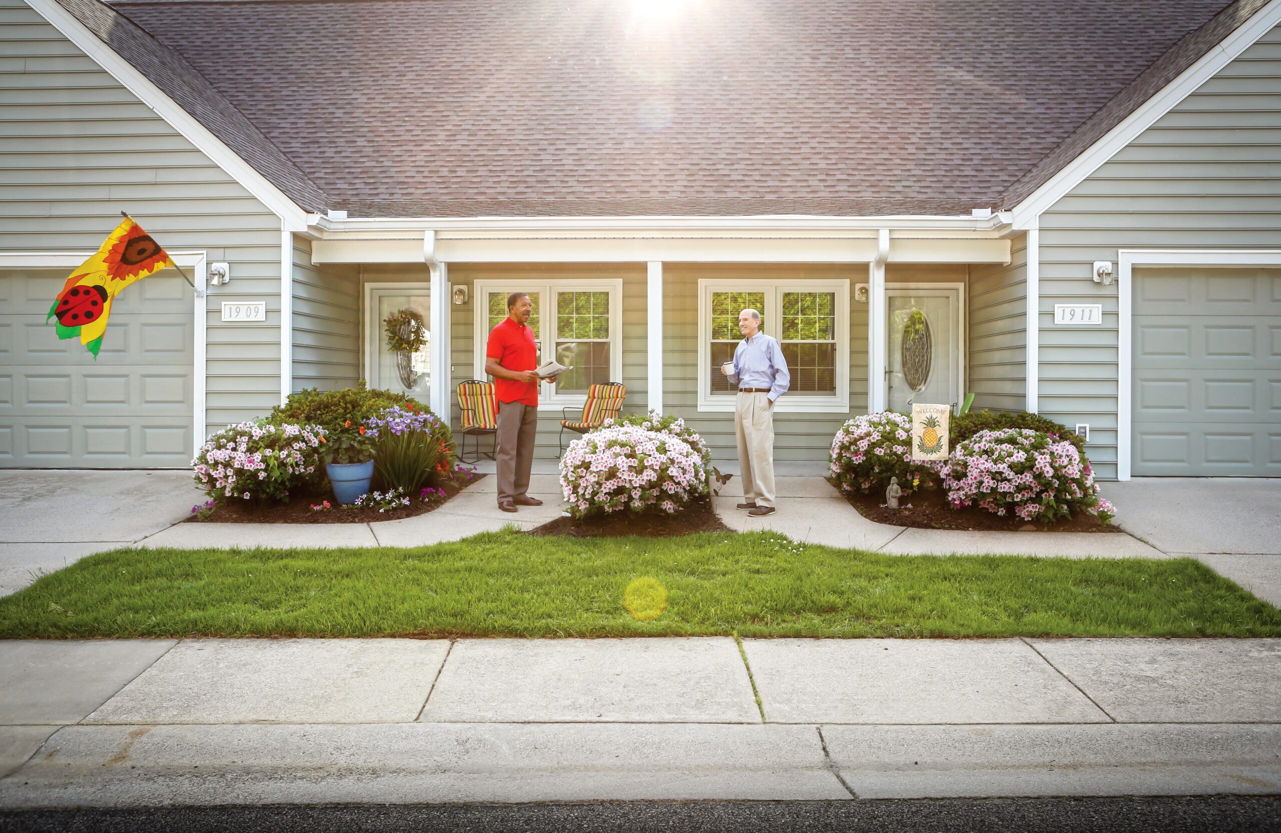 Two residents enjoying conversation outside their home