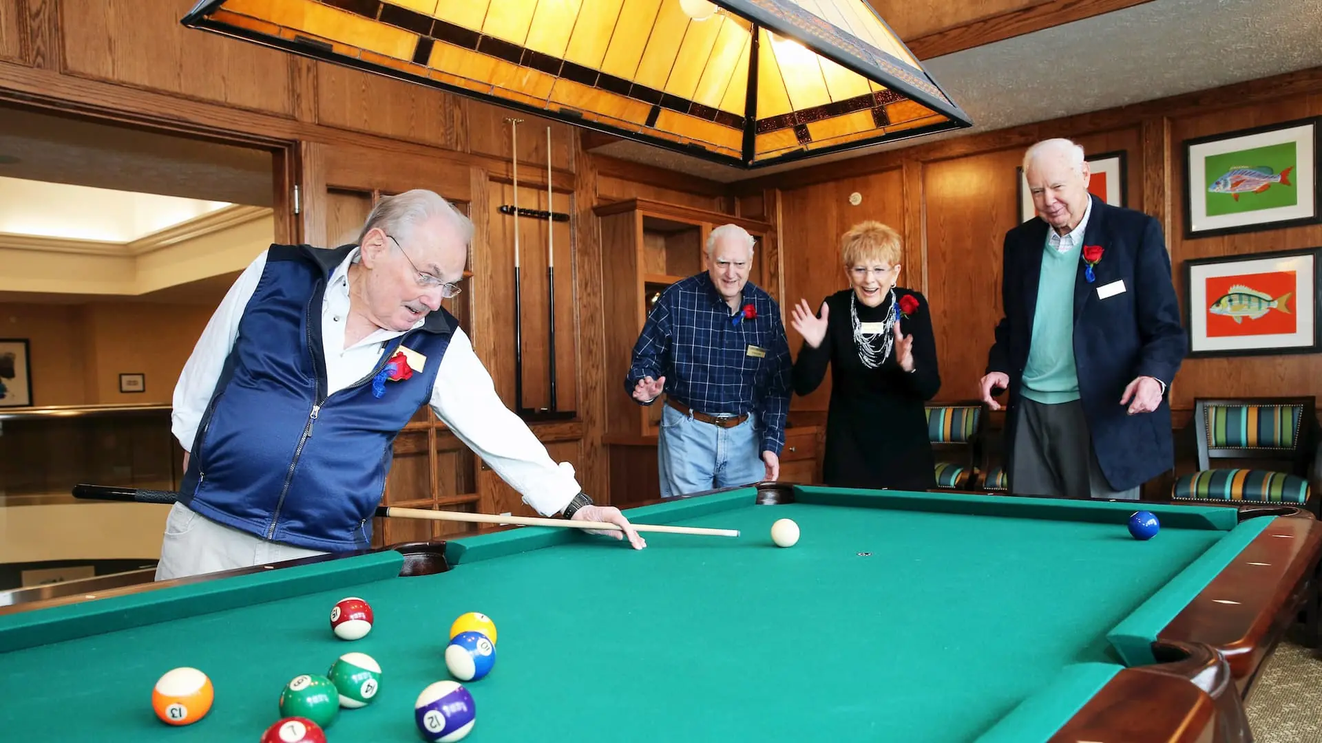 Residents enjoying a game of billiards in a common area