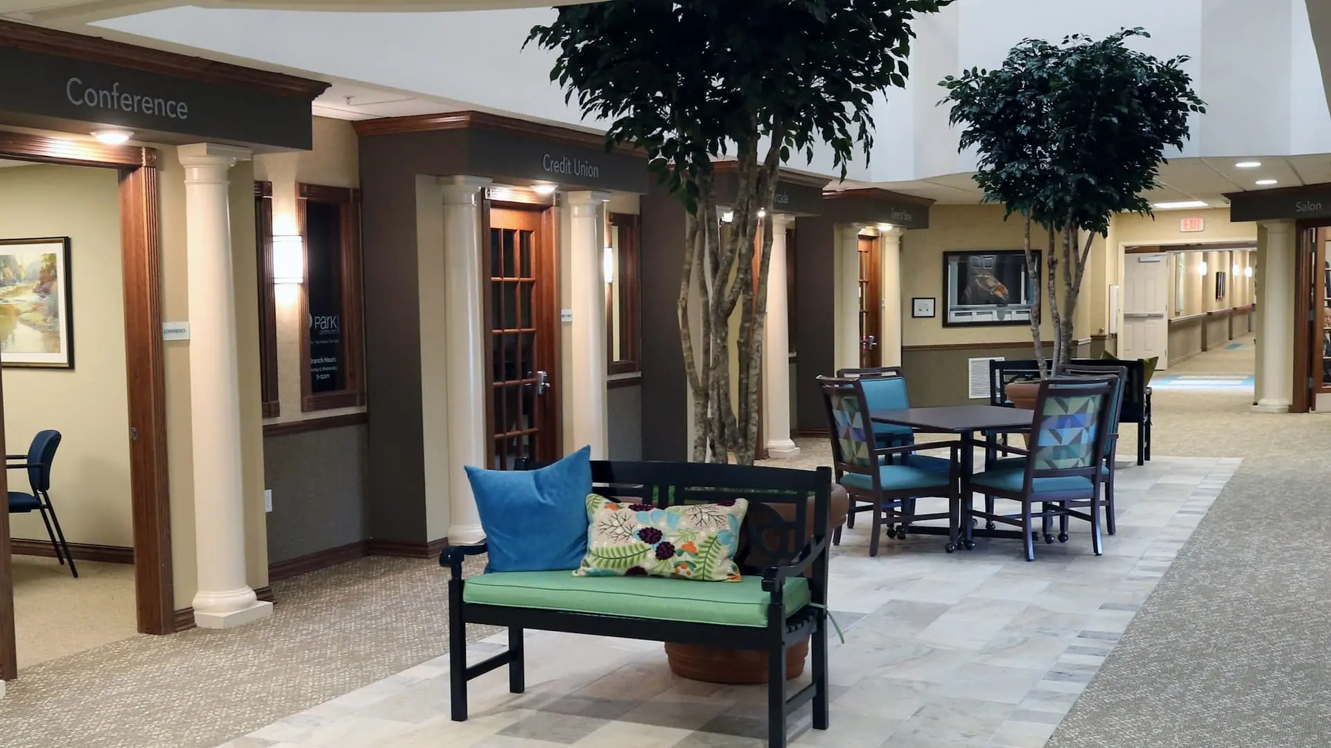 Interior common area with seating and decorative trees