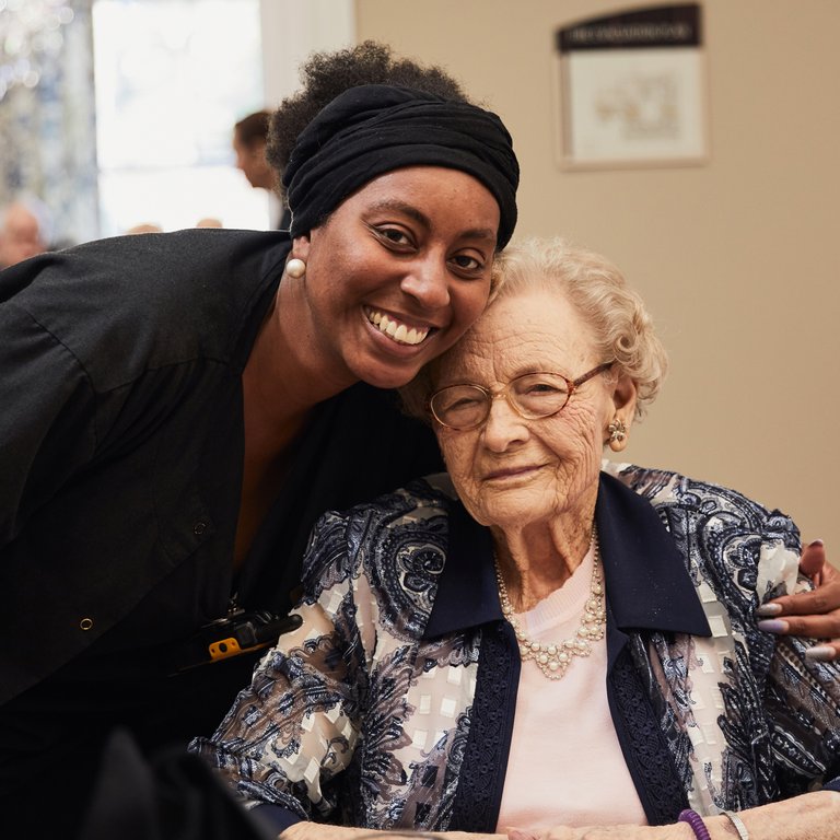 Care staff member smiling with a resident