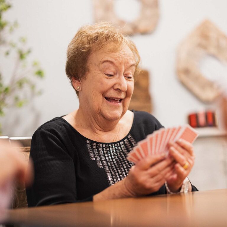 Resident enjoying a card game with friends