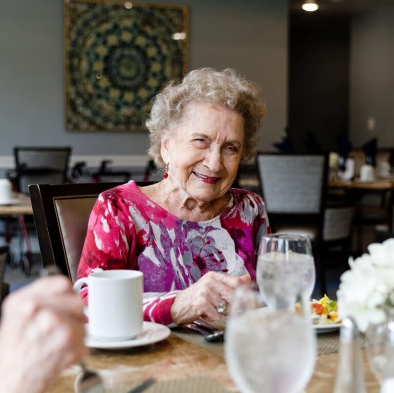 A resident enjoying a meal in the dining room