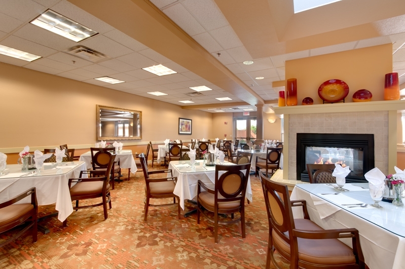 Elegant dining room with set tables and fireplace