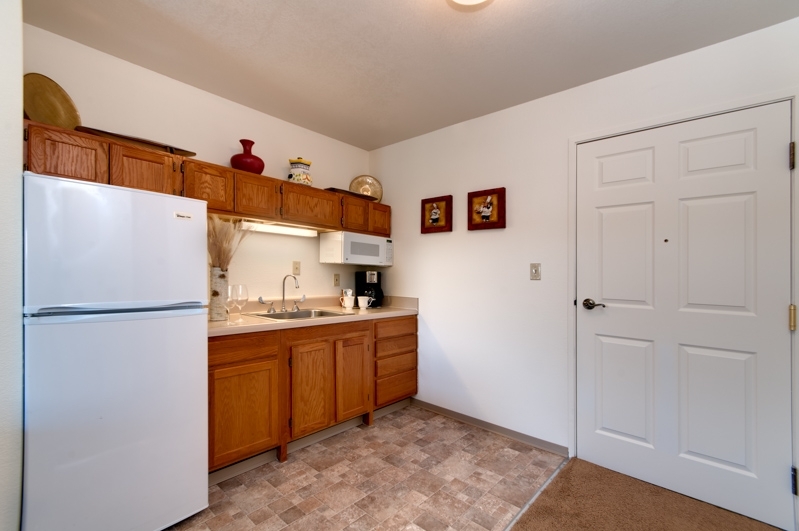 Interior kitchen space with cabinets and appliances