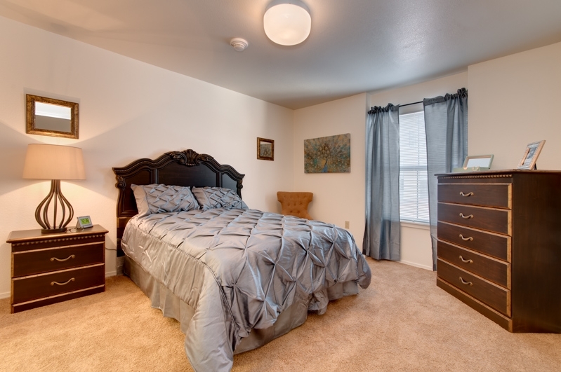 Cozy bedroom with a bed, dresser, and decor