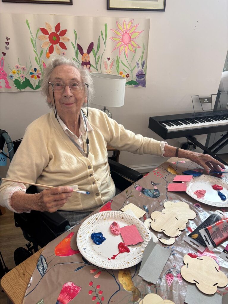 Senior woman engaged in a creative art activity.