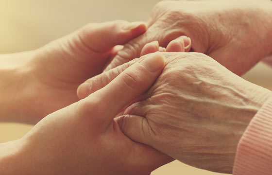 Gentle hands holding each other, symbolizing care.