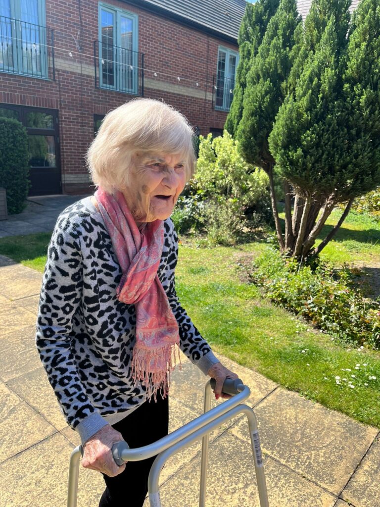 Resident enjoying the outdoor garden area