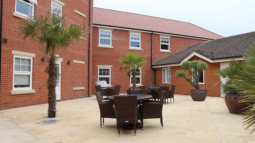 Outdoor seating area with palm trees and tables
