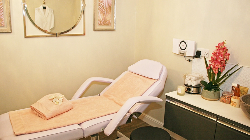 Spa treatment room with a massage bed and decor