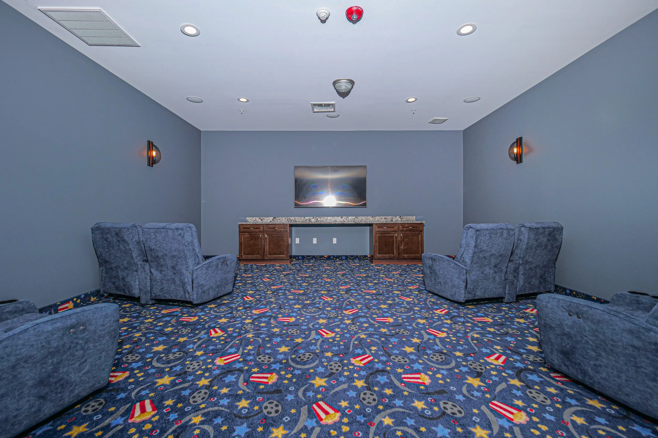 Cozy lounge area with blue carpet and comfortable seating