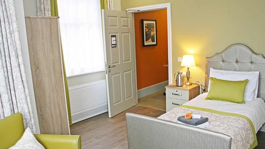 Neat, inviting resident bedroom with a touch of decor.