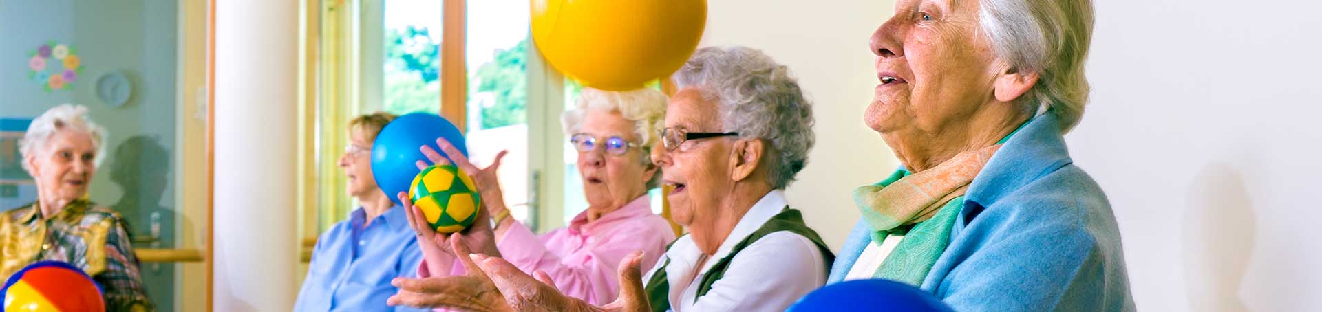 Seniors participating in a group activity with balls.