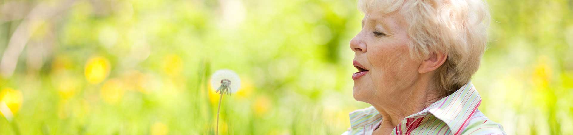 Senior woman enjoying outdoor nature in a garden