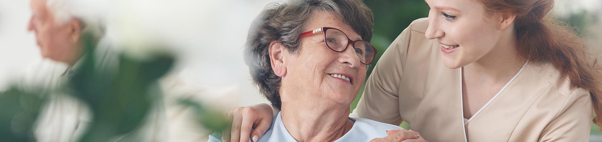 Caregiver and resident sharing a joyful moment