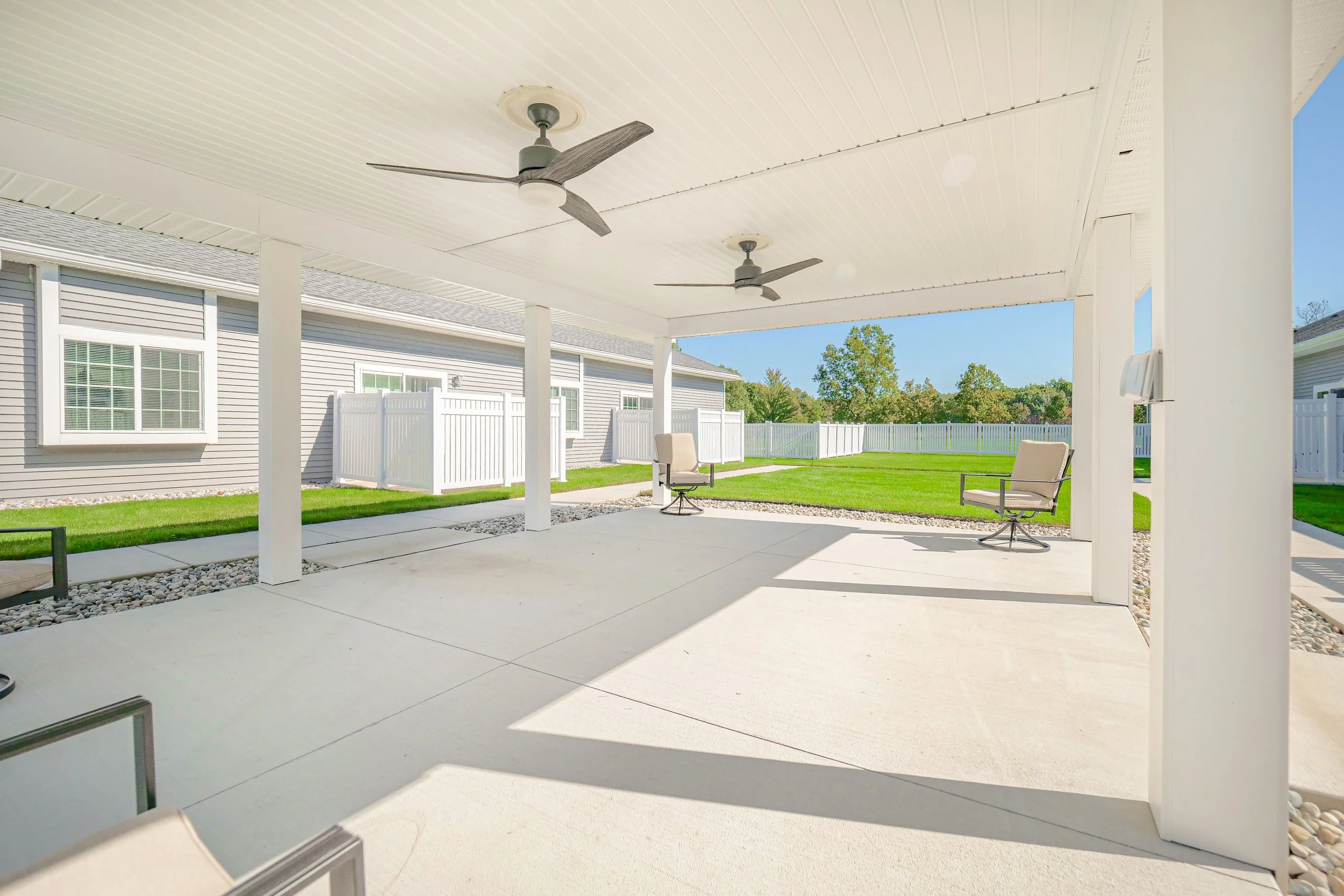 Covered outdoor seating area with green space