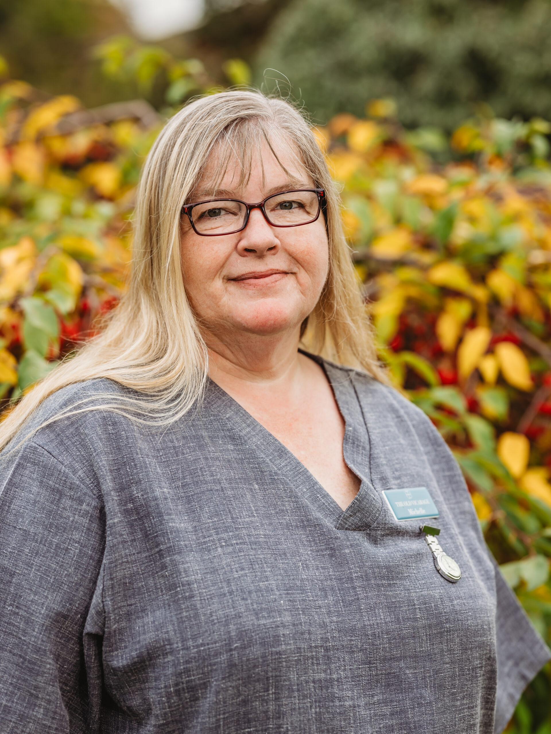 Staff member smiling in outdoor garden area