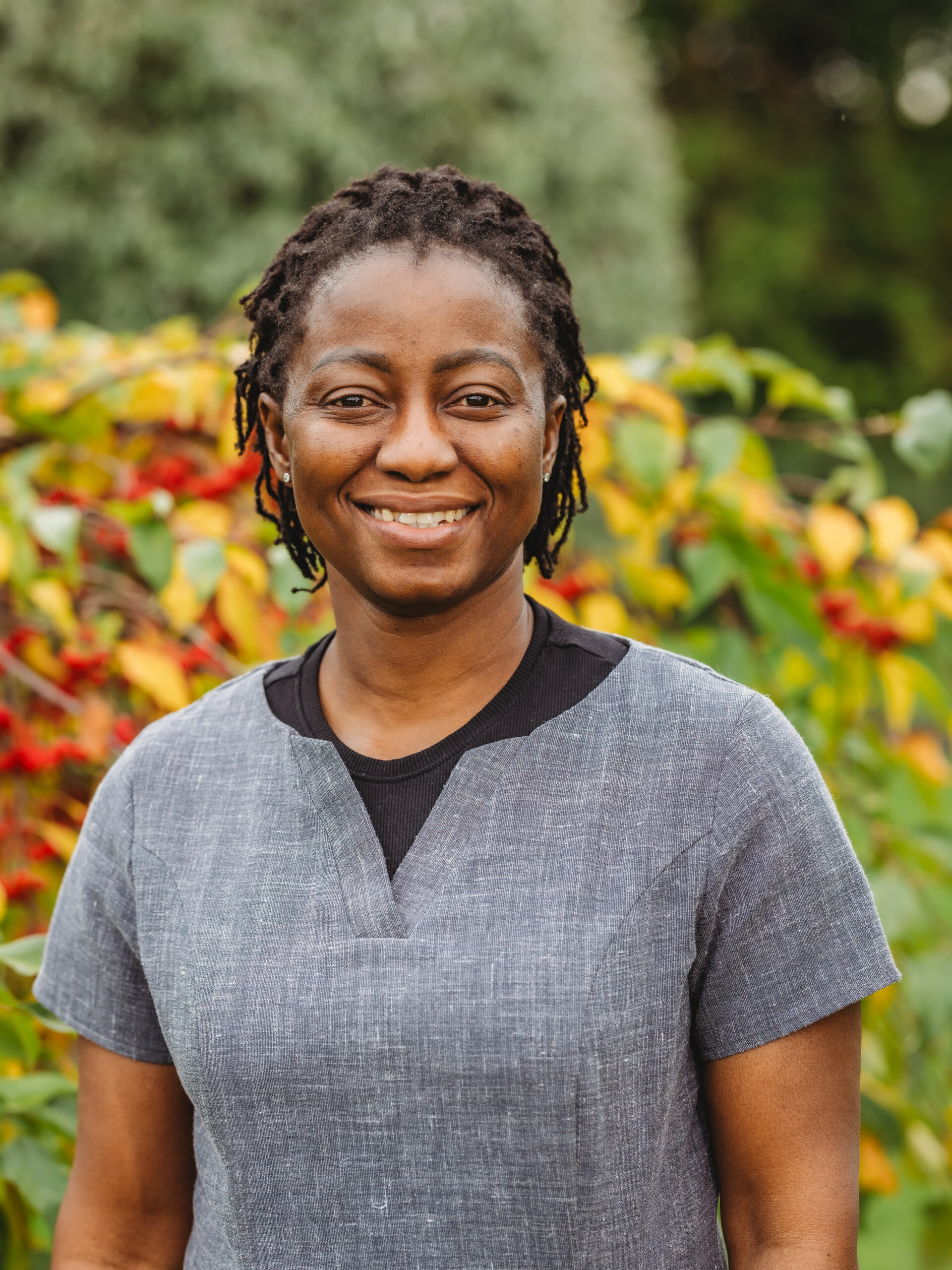 Staff member smiling in a garden