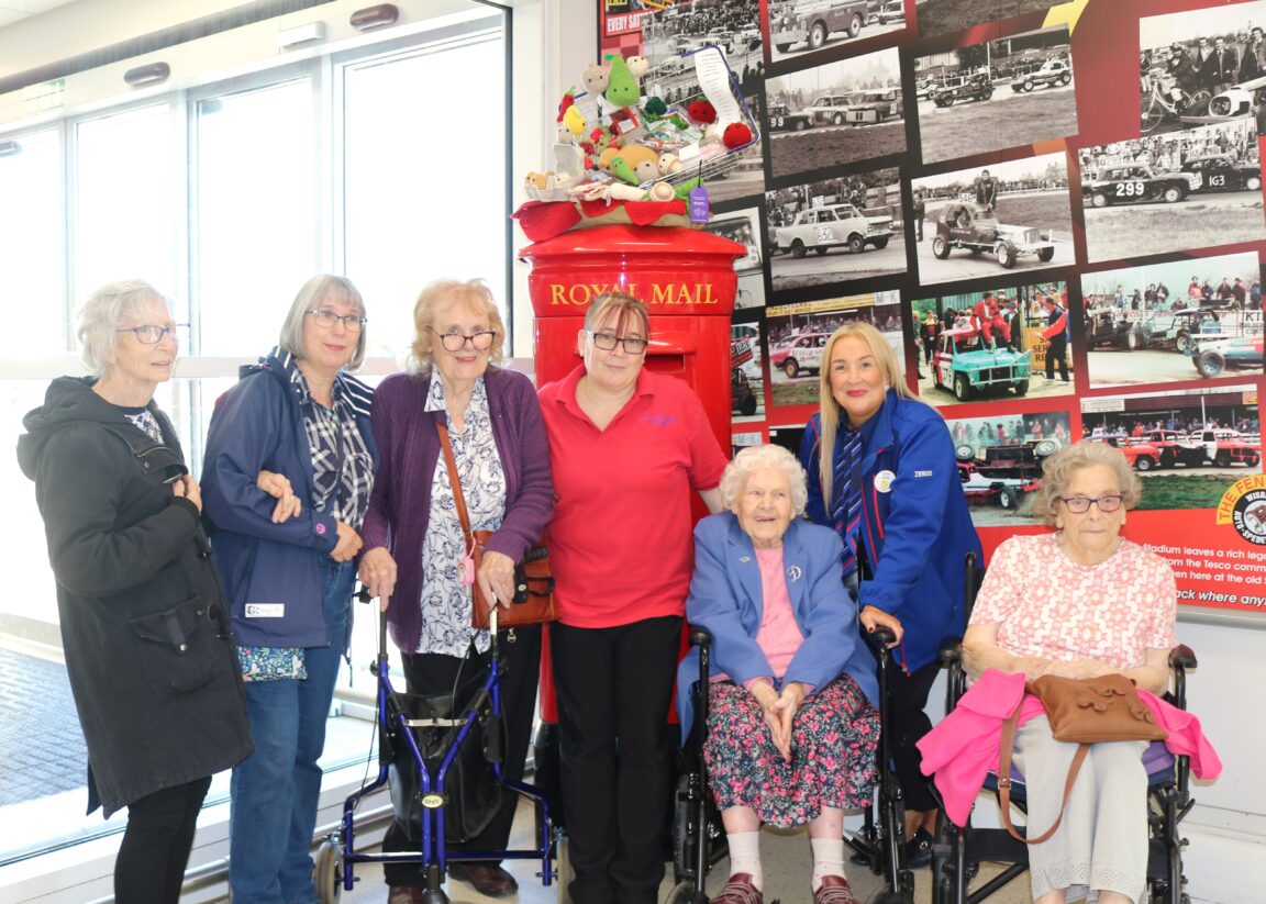 Residents and staff smiling in a common area