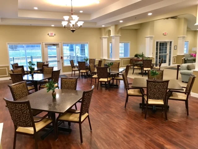 Dining area with tables and chairs in a bright interior.