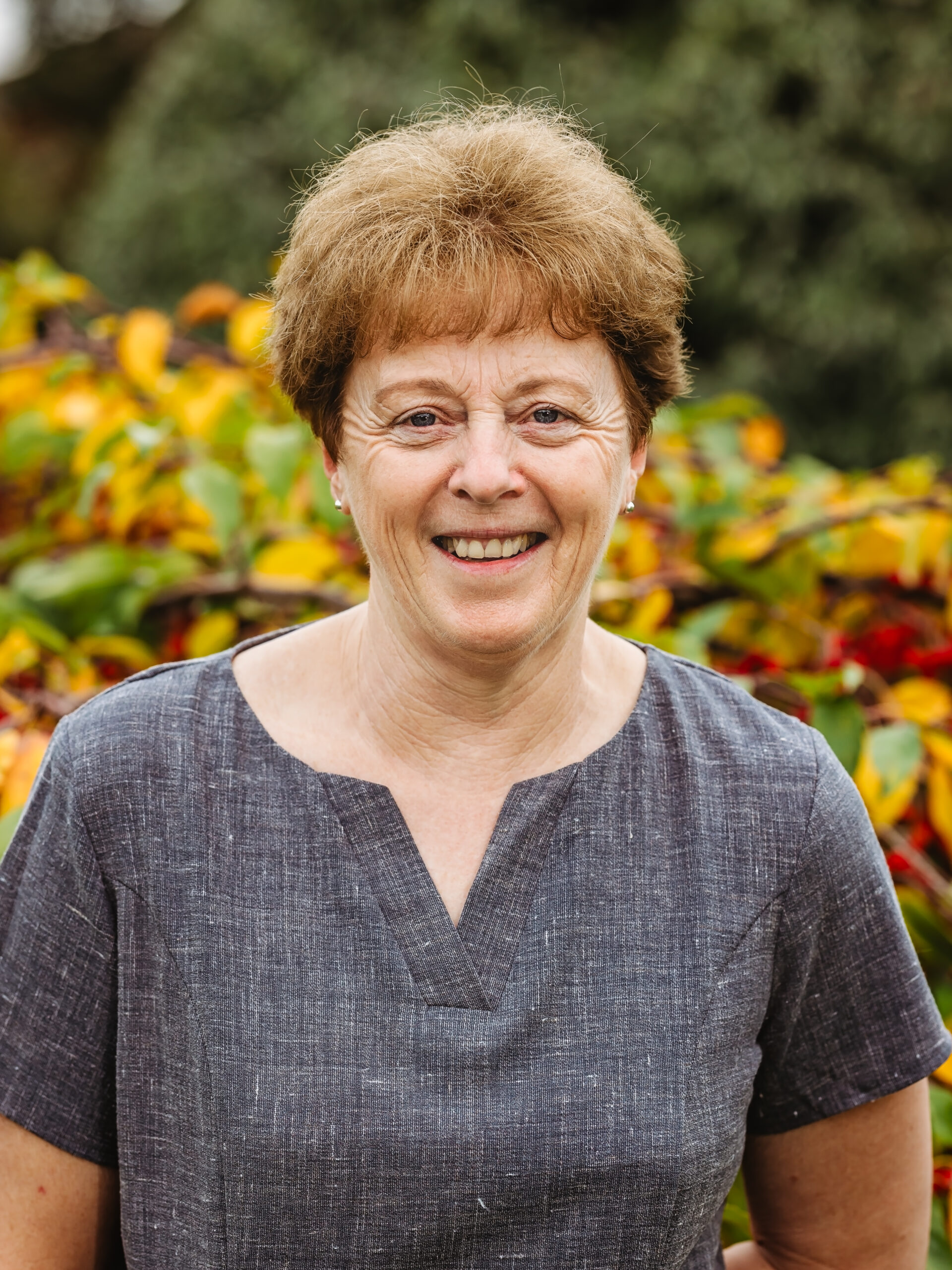 Smiling staff member outdoors in a garden