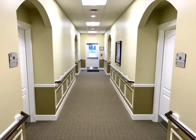 Hallway with doors and signage in a facility