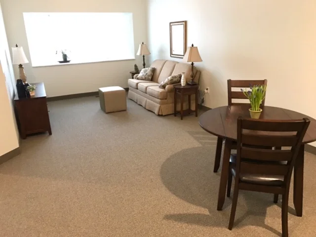 Cozy living space with sofa and dining table.