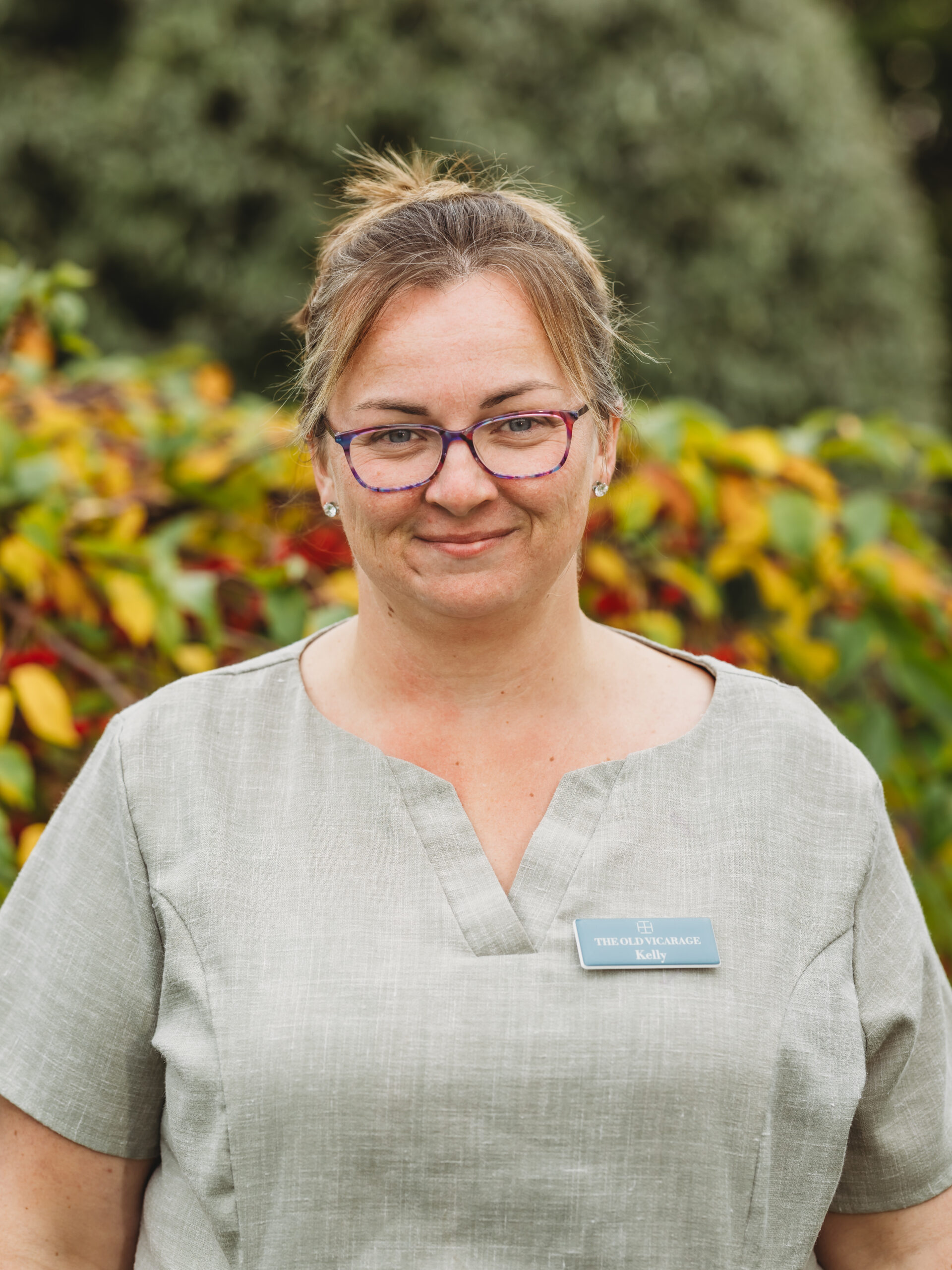 Staff member smiling in an outdoor space