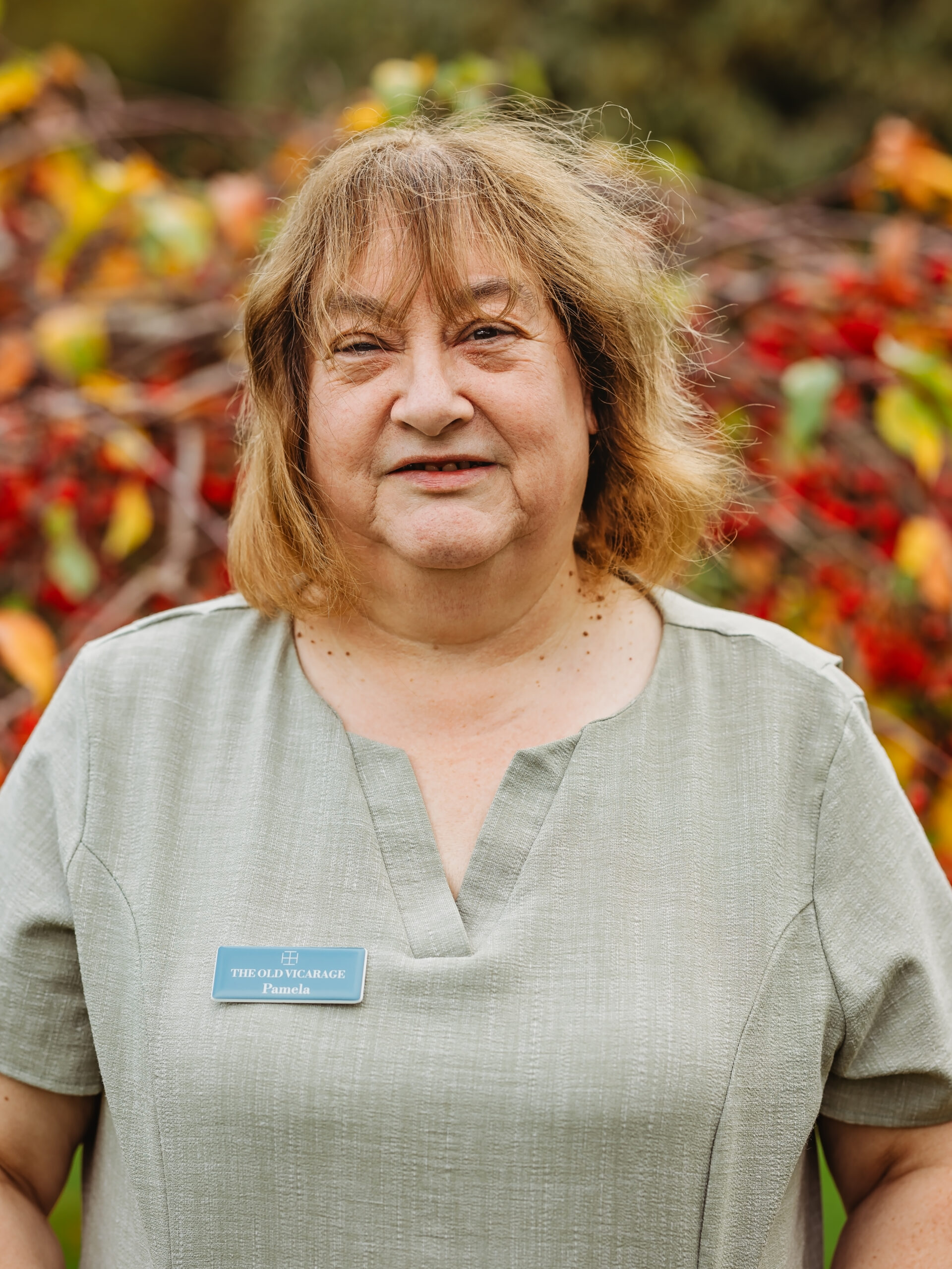 Resident staff member posing outdoors.