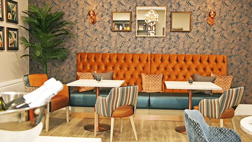 Cozy common area with seating and decorative wallpaper.