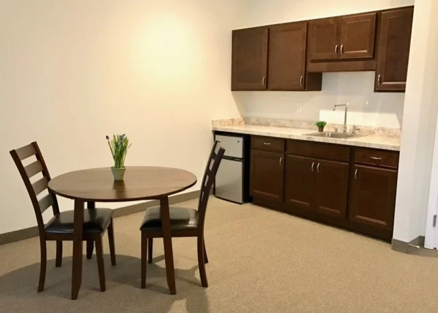 Cozy kitchenette and dining area in a resident room.