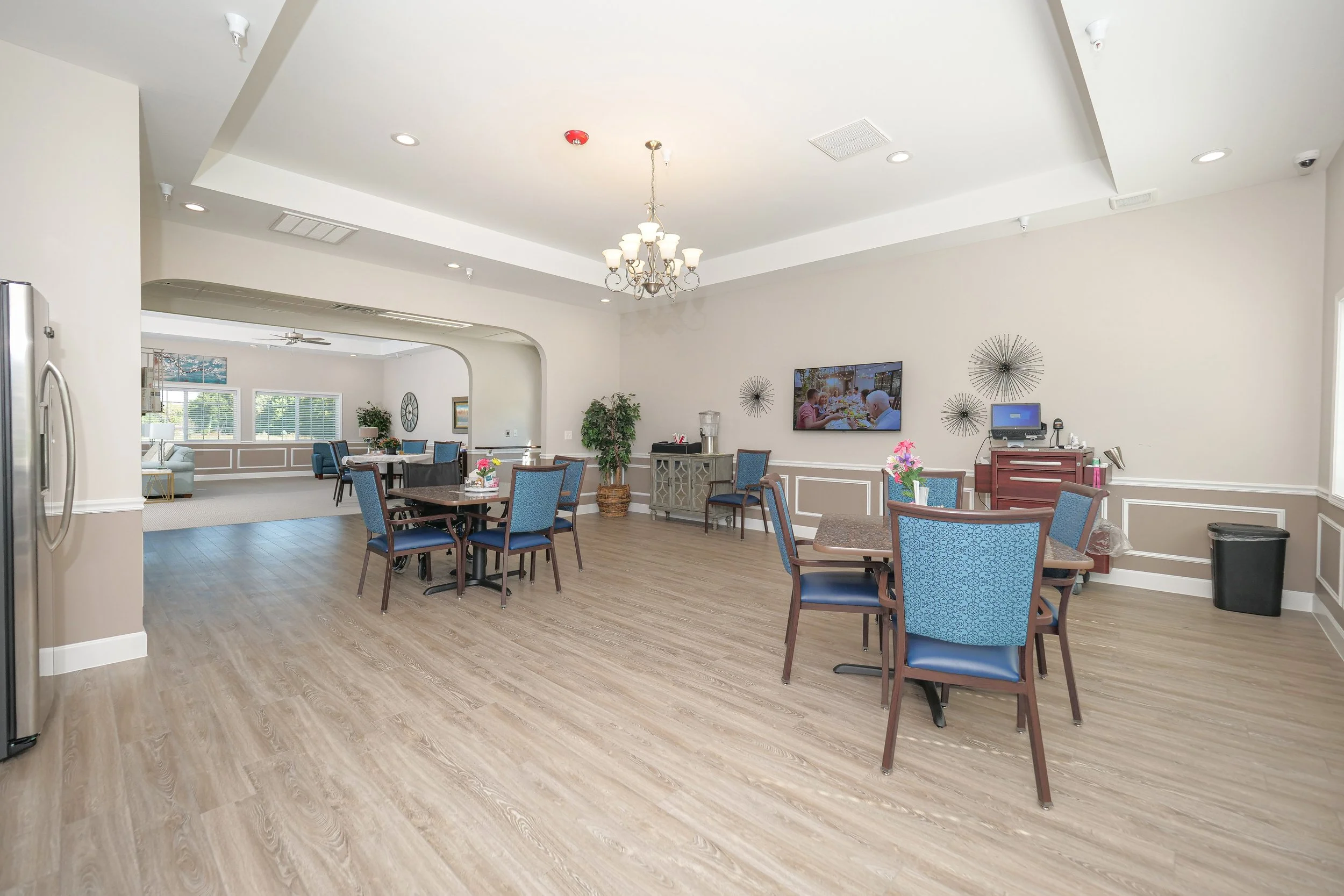Bright and spacious dining area with tables and chairs.