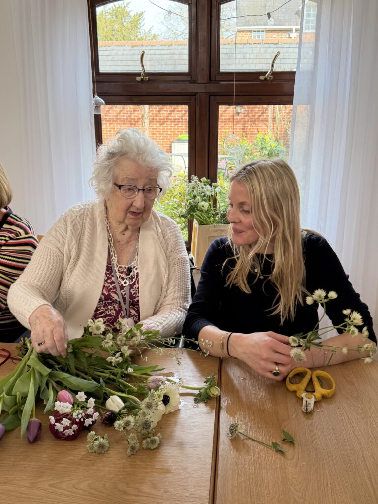 Residents engaged in a flower arranging activity