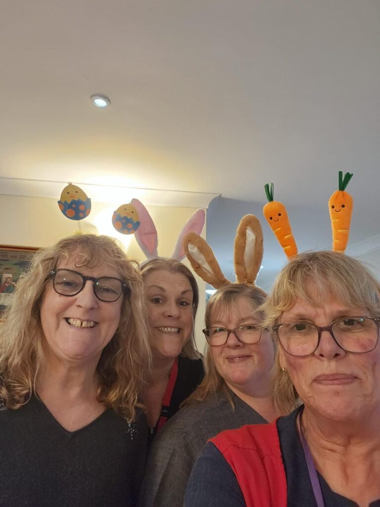 Staff members celebrating with festive headbands.